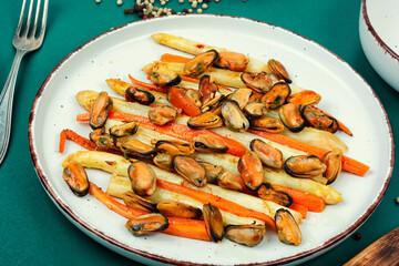 Delicious seafood mussels with asparagus, salad.