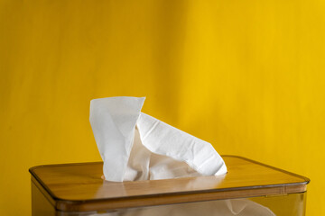close up of tissue box on isolated yellow background