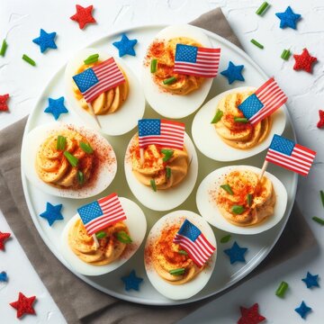 Deviled eggs decorated with American flags and sprinkles, perfect for a patriotic celebration.
