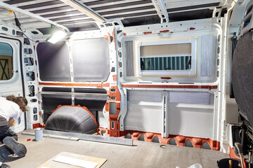 Camper van conversion. Insulation Floor of the transporter, motorhome after anti-rust paint. Conversion DIY Jumper van, foam insulation inside of a camper van © ImageSine