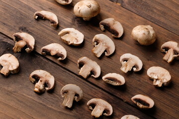 champignons are edible mushrooms that are almost round like buttons. mushroom is the most widely cultivated mushroom in the world. Agaricus bisporus. served on a rustic wooden table. 