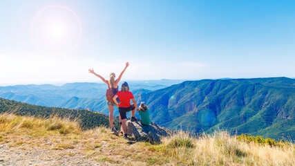 Family having fun and enjoying panoramic view of mountain landscape