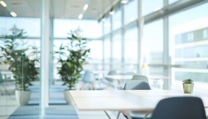 Fototapeta premium Beautiful blurred background of a light modern office interior with panoramic windows and beautiful lighting.