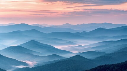 Obraz premium A panoramic view of the Blue Ridge Mountains at sunrise, the sky painted in soft shades of pink and orange, highlighting the misty valleys between the layered hills.