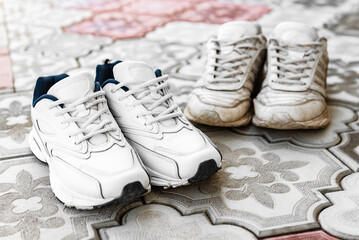 Pair of clean and dirty white sneakers.