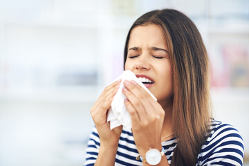 Young woman and sick with toilet paper for flu season, allergies or infection in home. Female...