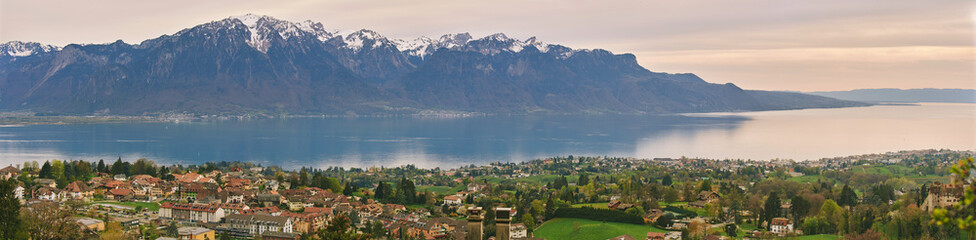 Panoramic banner with landscape view of swiss alpine mountains and small villages between Montreux...