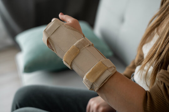 Hand injury. Broken wrist and arm with bandage or immobilizer. woman uses hand splints. Inflammation