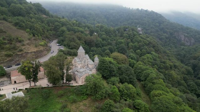 Medieval Haghartsin Monastery in Armenia perched on misty mtn slope