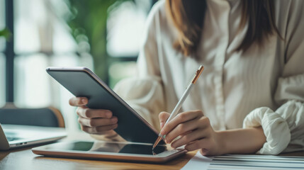 Cropped businesswoman using digital tablet at home