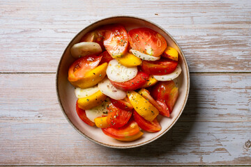 Salad plate, with tomato, peach and cut cucumber. Ready to eat.