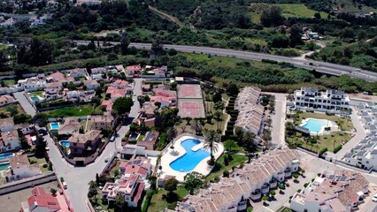 Aerial view of architecturally-designed modern prestige homes with pools in outer suburban Spain