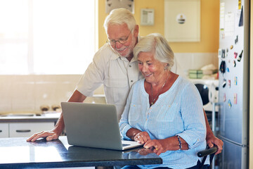 Elderly, couple and smile with laptop in kitchen for internet, website and reading elections...