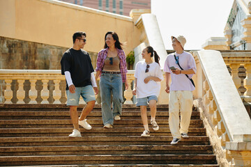 Group of friends walking and smiling on stairs, enjoying their time together