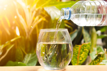 water poured into a glass from a plastic bottle