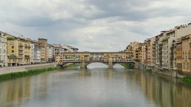 Serene view of the Ponte Vecchio bridge over Arno River in Florence.
