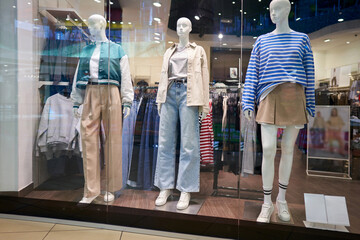Shopping center. Showcase department of women's clothing with mannequins.