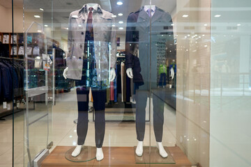 Department of men's clothing in the shopping center. Mannequins in demi-seasonal clothes.