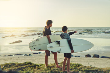Learning, surf and kids on beach with board for adventure on vacation, holiday or sport in water. Child, surfer and search the current in waves for safety on island in summer, pointing or teens relax