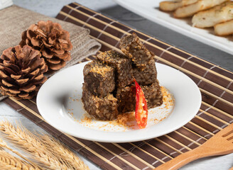 Bouncy purple rice cake with wheat, spoon and fork served in dish isolated on napkin side view of taiwanese food