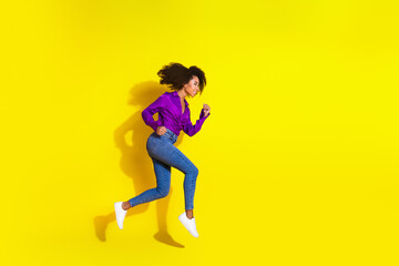 Full body photo of lovely young lady run hurry black friday dressed stylish violet garment isolated on yellow color background