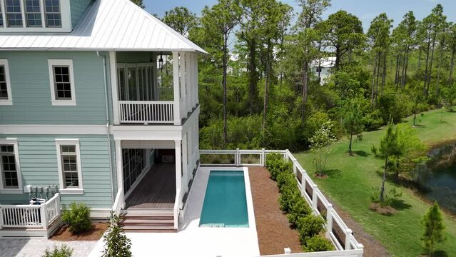 Luxury Vacation House With Outdoor Pool And Nearby Lake In 30A Florida, USA. drone sideways shot