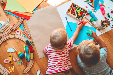 Kids draw and make crafts. Kindergarten or preschool background.