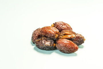 Fresh dried dates in close-up on a light background.