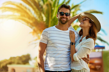 Couple, people and happy on holiday in outdoor with sunglasses for summer exploring and fun in Spain. Relationship, love and smile with support on vacation, trip and travel together as soulmate