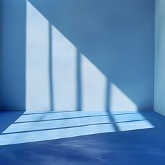 Obraz premium A blue background with the shadow of windows, light and shadows on the wall in a minimalist style