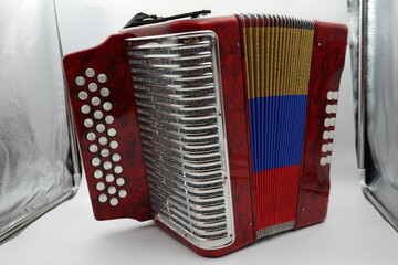 A colorful vallenato accordion from Colombia, showcasing the vibrant red, yellow, and blue colors...