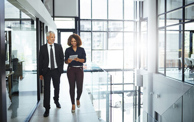 Business people, mentor and helping employee with tablet for advice, teamwork and collaboration in...