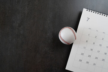baseball and calendar on black background, top view sport concept