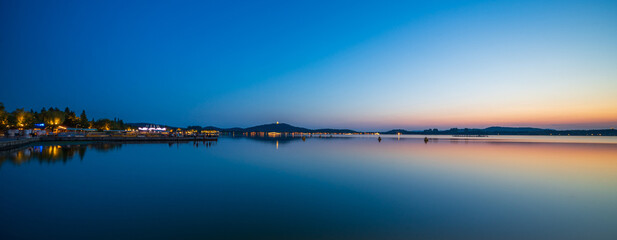 Serene Waterfront at Sunset with Clear Sky