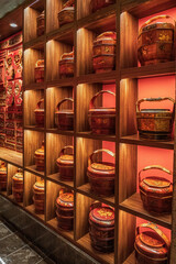 Traditional Chinese Tea Caddies on Wooden Shelves