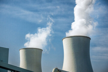 Expansive Power Plant Facilities with Cooling Towers Under Blue Skies