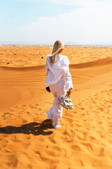 Woman backpacker travel in United Arab Emirates, Rub al Khali desert. Explore nature, sand dunes...