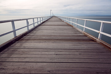 Fototapeta premium Urangan pier jetty, Hervey Bay, Queensland, Australia, timber tourist destination travel holiday vacation, empty no people, long exposure