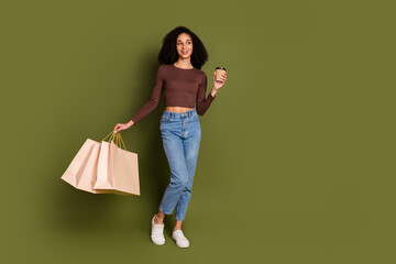 Full length photo of lovely young lady look empty space shopper coffee dressed stylish brown...