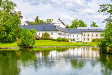 A picturesque view of Velke Losiny Chateau in Czechia, showcasing the beautiful white building...