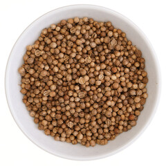 Overhead view of coriander seeds (Coriandrum sativum) in a white bowl, isolated on white background
