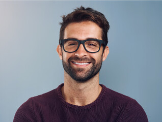 Studio, glasses and man with smile, portrait and wellness with eye care, product and lens for vision. Blue background, face and happiness for person, prescription and eyewear with fashion in USA