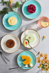 Assorted Cheesecakes on Colorful Plates Top View - Delicious Dessert Spread