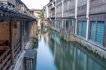Discover China Wuzhen's ancient architecture, where old stone paths and bridges reflect on peaceful waters. Experience the charm of historic buildings along serene rivers..