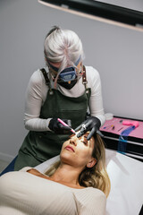 Professional microblading procedure in modern cosmetic studio
