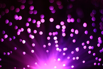 Festive dark purple background with boke and light on bottom