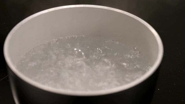 the water is boiling and the cook is ready to throw in the pasta
