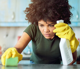 Table, spray and woman with cleaning in kitchen for hygiene, housekeeping or maintenance at home. Bottle, person and detergent with gloves in house for sanitation, health or removal of bacteria