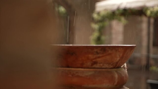 during the flood a terracotta amphora is hit by the rain
