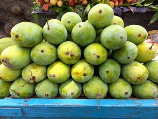 Fresh and juicy Mango fruits,Bunch of green and yellow ripe mango on,Popular varieties of mangoes in India,Selective of pile of yellow mangoes,Popular indian varieties  mango fruits 

